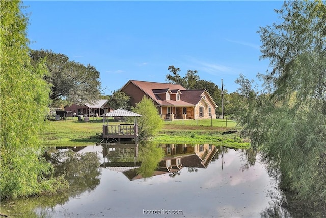 rear view of property with a gazebo and a water view