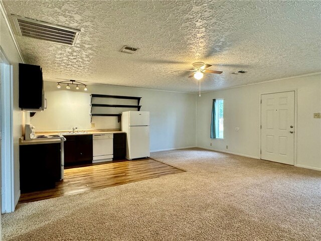 kitchen with a textured ceiling, white appliances, light hardwood / wood-style flooring, and ceiling fan