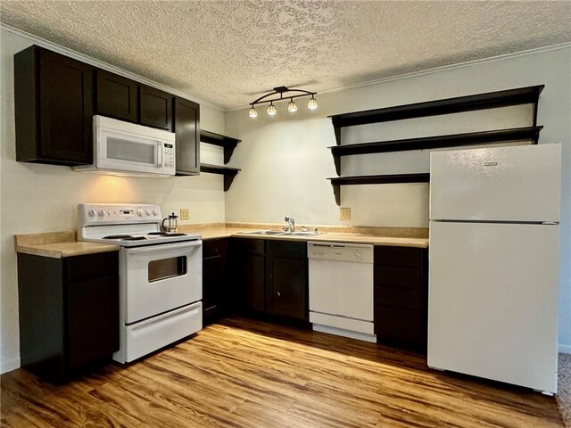 kitchen with dark brown cabinetry, sink, a textured ceiling, white appliances, and light wood-type flooring