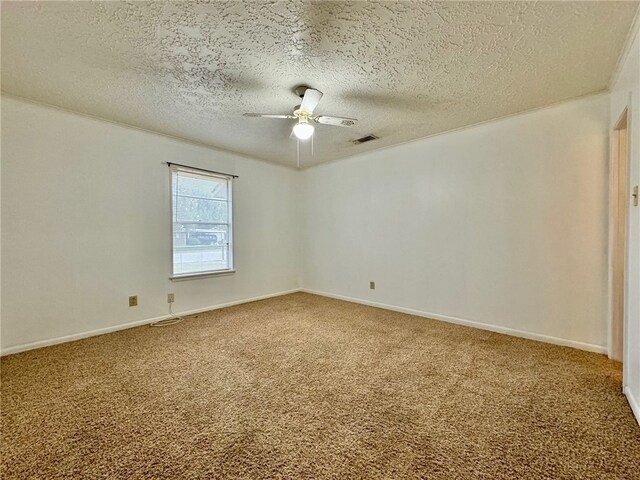 carpeted spare room featuring ceiling fan and a textured ceiling