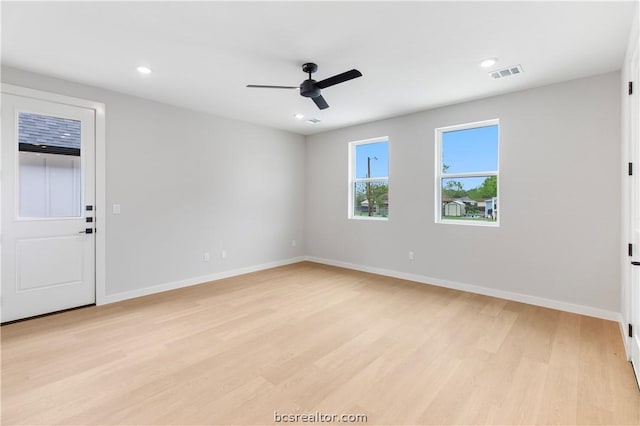 spare room with ceiling fan and light hardwood / wood-style flooring