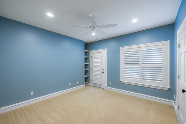 unfurnished bedroom with ceiling fan and light carpet