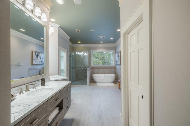 bathroom featuring vanity, ornamental molding, and shower with separate bathtub