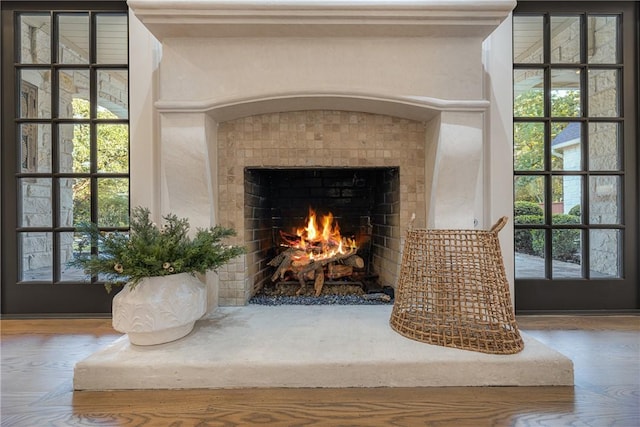 room details featuring hardwood / wood-style flooring and a tiled fireplace