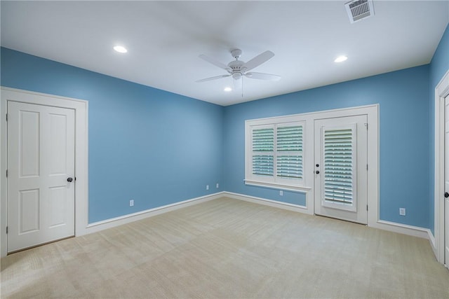 unfurnished bedroom featuring light colored carpet and ceiling fan