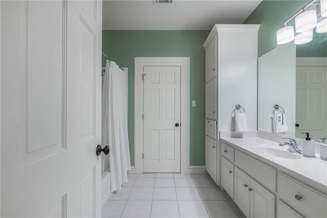 bathroom featuring tile patterned flooring and vanity