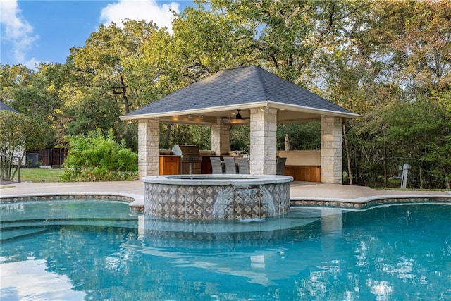 view of swimming pool with a gazebo, ceiling fan, and area for grilling