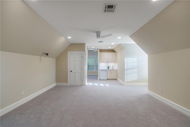 bonus room featuring light colored carpet, vaulted ceiling, and ceiling fan