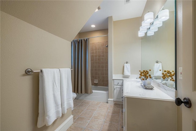 full bathroom with tile patterned floors, shower / bath combo with shower curtain, toilet, and vanity