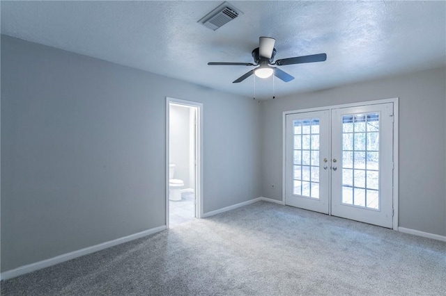 unfurnished room featuring carpet, french doors, a textured ceiling, and ceiling fan