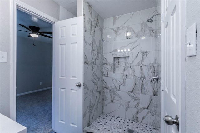 bathroom featuring ceiling fan and tiled shower