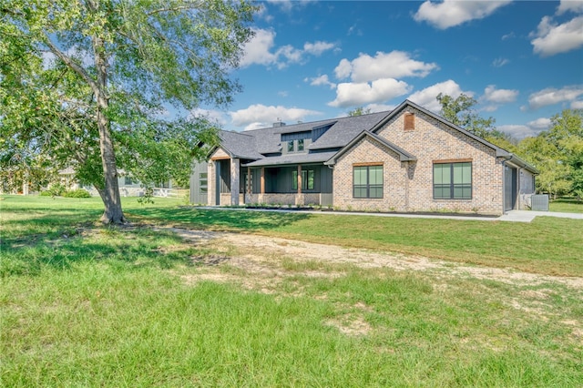 exterior space featuring central AC and a front lawn