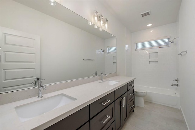 full bathroom featuring vanity, toilet, tiled shower / bath combo, and tile patterned flooring