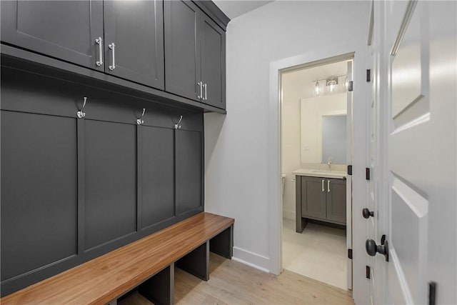 mudroom featuring sink and light hardwood / wood-style flooring