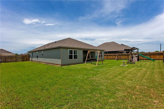 137 Windmill Rd, Snook, TX 77878 - rear view of house with a playground and a fenced backyard