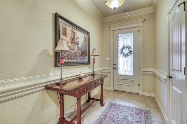 2703 Wood Ct, Bryan, TX 77808 - entrance foyer featuring light tile patterned floors and crown molding