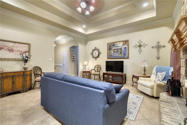 2703 Wood Ct, Bryan, TX 77808 - living area with arched walkways, ceiling fan, light tile patterned floors, ornamental molding, and a tray ceiling