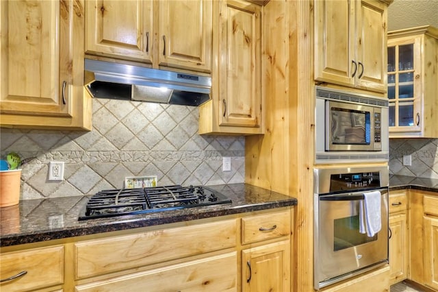 2703 Wood Ct, Bryan, TX 77808 - kitchen with appliances with stainless steel finishes, under cabinet range hood, backsplash, light brown cabinets, and glass insert cabinets