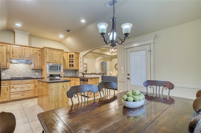 2703 Wood Ct, Bryan, TX 77808 - dining room featuring a chandelier, vaulted ceiling, arched walkways, light tile patterned flooring, and recessed lighting