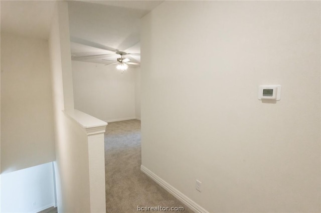 hallway featuring light colored carpet