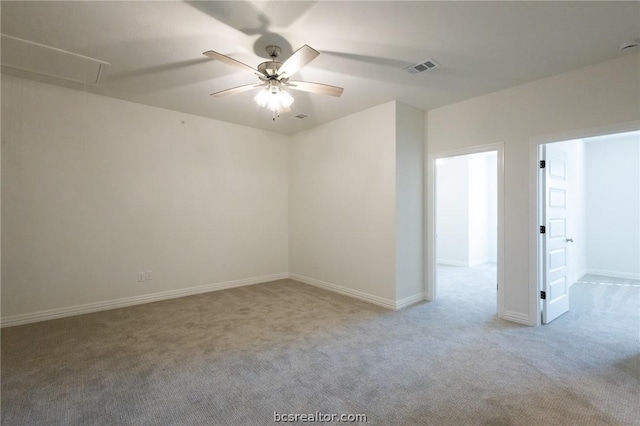 spare room with ceiling fan and light carpet