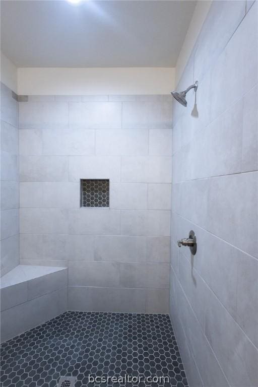 bathroom with tiled shower