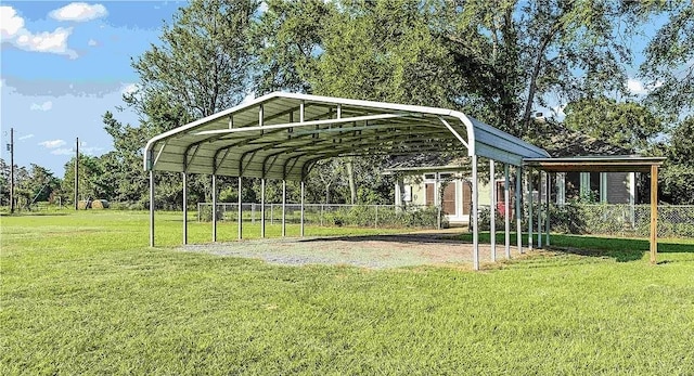 view of parking with a carport, fence, and driveway