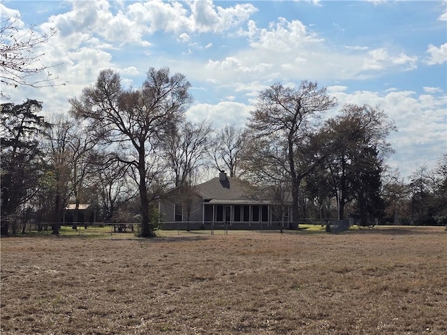 view of yard featuring a sunroom and fence