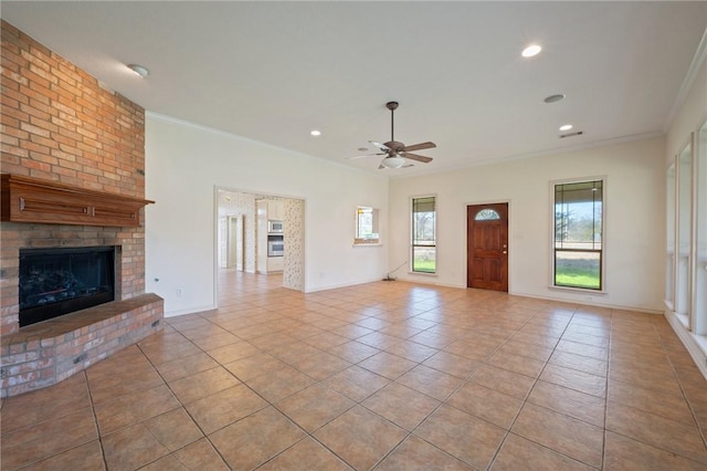 unfurnished living room featuring light tile patterned floors, baseboards, a fireplace, and ornamental molding