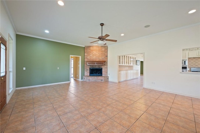 unfurnished living room with ornamental molding, a fireplace, ceiling fan, and light tile patterned flooring