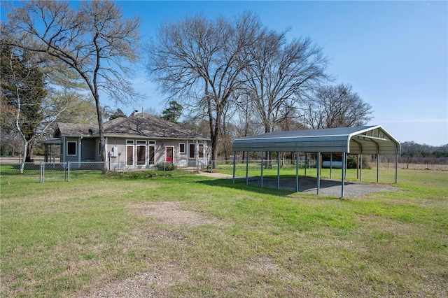 view of yard with fence and a detached carport