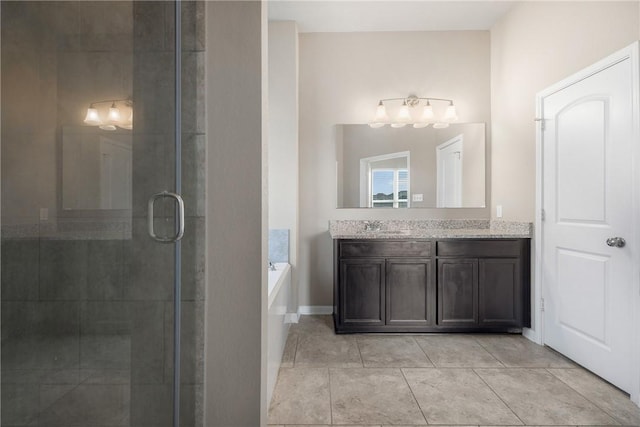 2099 Positano Loop, Bryan, TX 77808 - full bathroom with vanity, a stall shower, a bath, tile patterned flooring, and baseboards