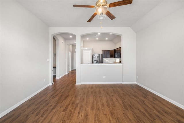 2099 Positano Loop, Bryan, TX 77808 - unfurnished living room with a ceiling fan, dark wood-style floors, baseboards, and arched walkways
