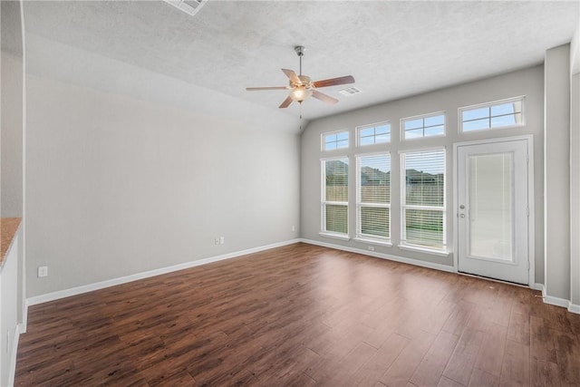2099 Positano Loop, Bryan, TX 77808 - empty room with ceiling fan, dark wood-style floors, baseboards, a textured ceiling, and vaulted ceiling