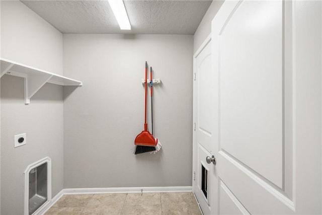 2099 Positano Loop, Bryan, TX 77808 - laundry room with hookup for an electric dryer, baseboards, and a textured ceiling