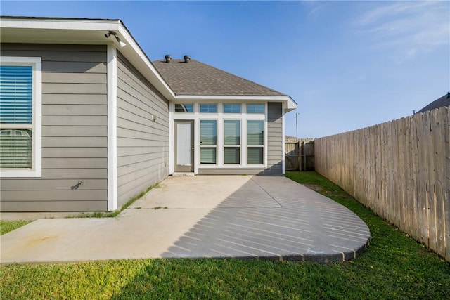 2099 Positano Loop, Bryan, TX 77808 - back of house with a patio, a fenced backyard, and roof with shingles