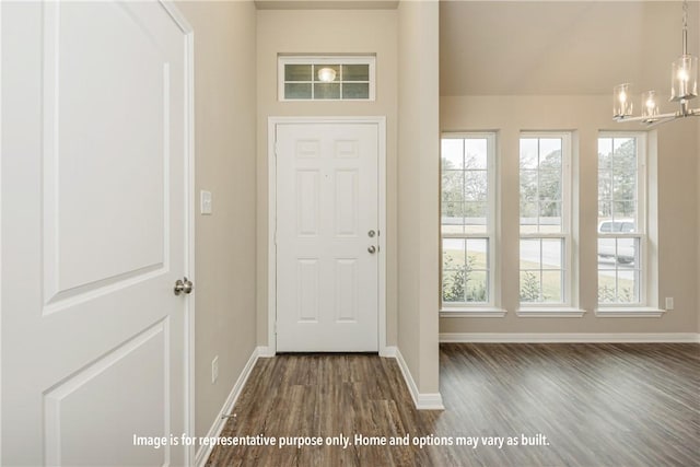301 Whaley St, Caldwell, TX 77836 - foyer with dark wood-style flooring, baseboards, and a chandelier