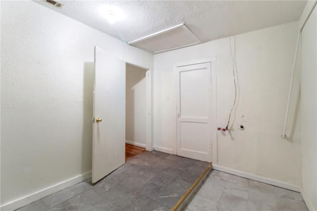 basement featuring a textured ceiling