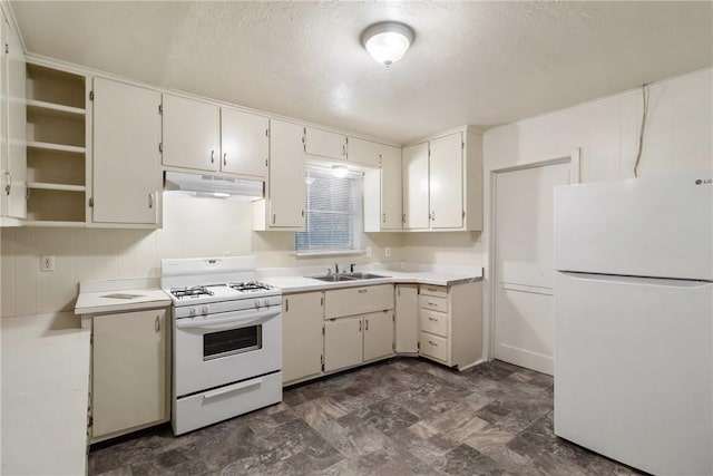 kitchen featuring white cabinetry, sink, white appliances, and a textured ceiling