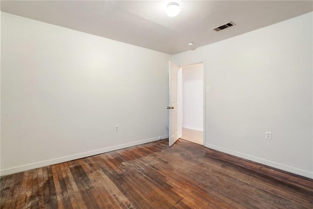 empty room with dark wood-type flooring