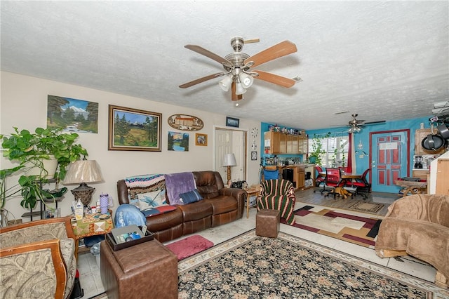 living room with hardwood / wood-style floors, a textured ceiling, and ceiling fan