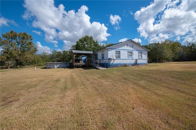 view of front of home with a front lawn and a pool side deck