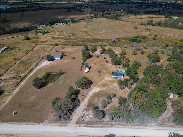 birds eye view of property with a rural view