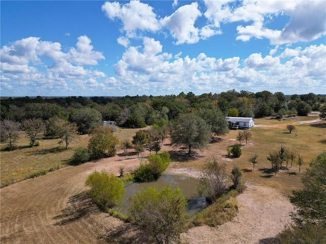 drone / aerial view featuring a rural view and a water view