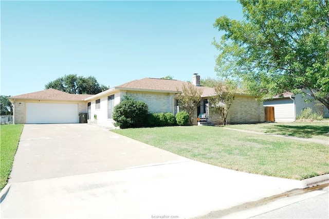 ranch-style house featuring concrete driveway, a chimney, an attached garage, and a front yard