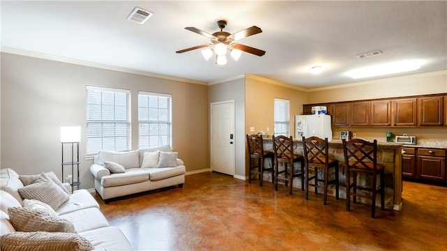 living area featuring visible vents, crown molding, finished concrete flooring, and baseboards