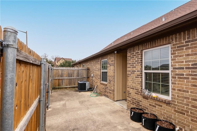 view of patio featuring central AC and fence