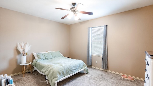 bedroom with a ceiling fan, baseboards, and carpet flooring