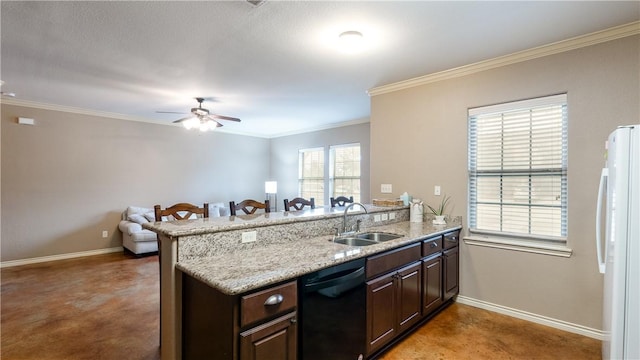 kitchen with a peninsula, a sink, dishwasher, and freestanding refrigerator