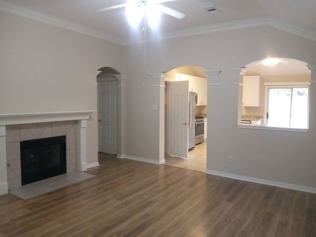 unfurnished living room featuring ornamental molding, wood finished floors, and visible vents